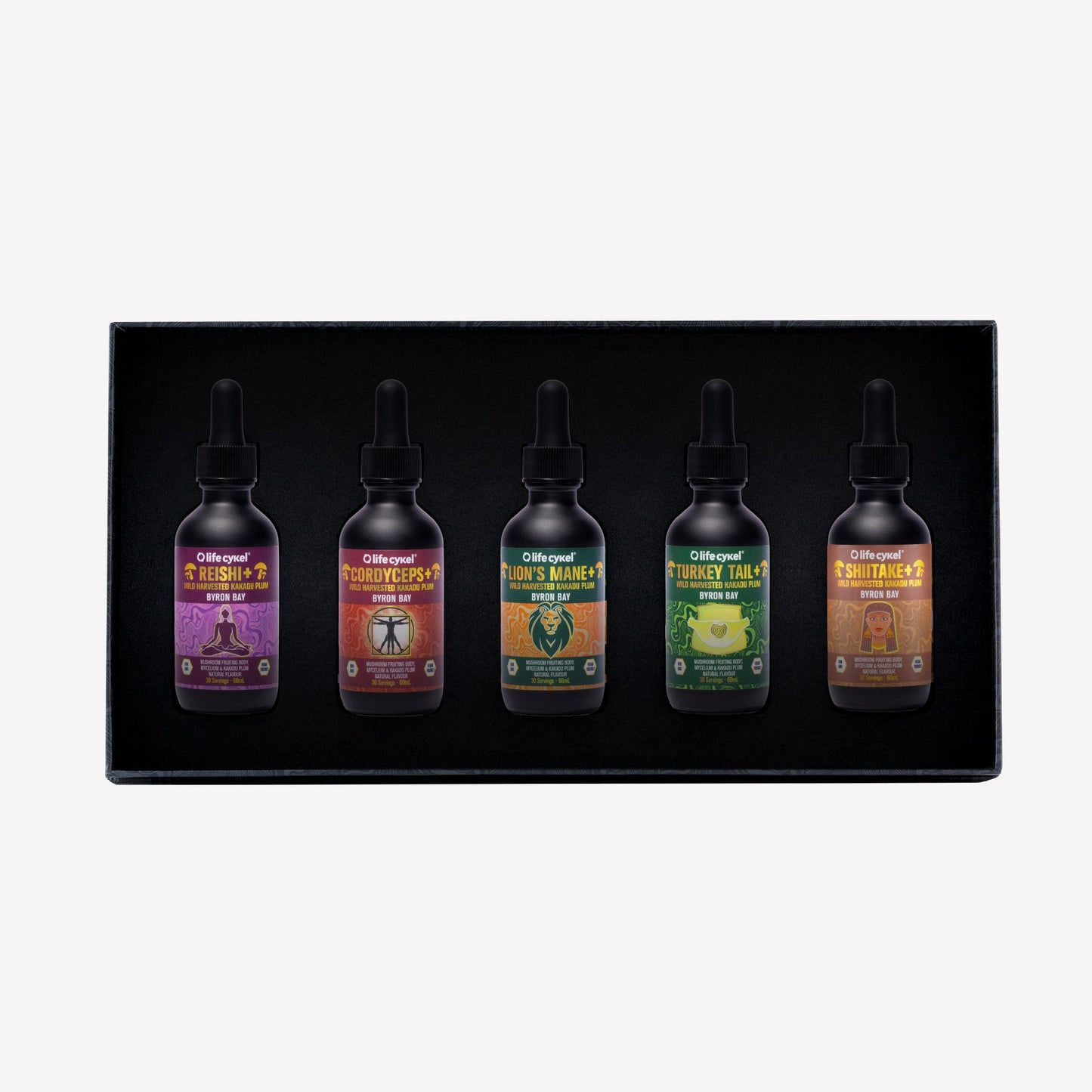 Five Lifecykel mushroom extracts  dropper bottles with colorful labels in a black box on a white background