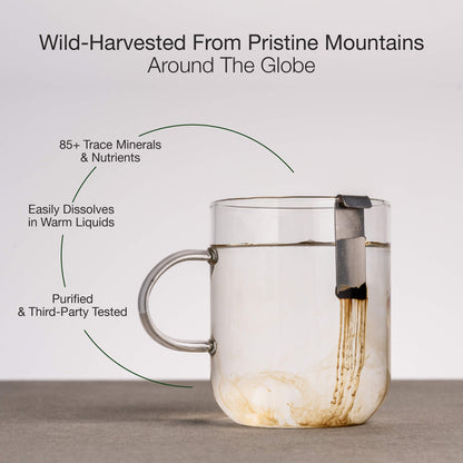 Clear glass mug with Lifecykel Shilajit on a light gray background, featuring text about Shilajit quality.