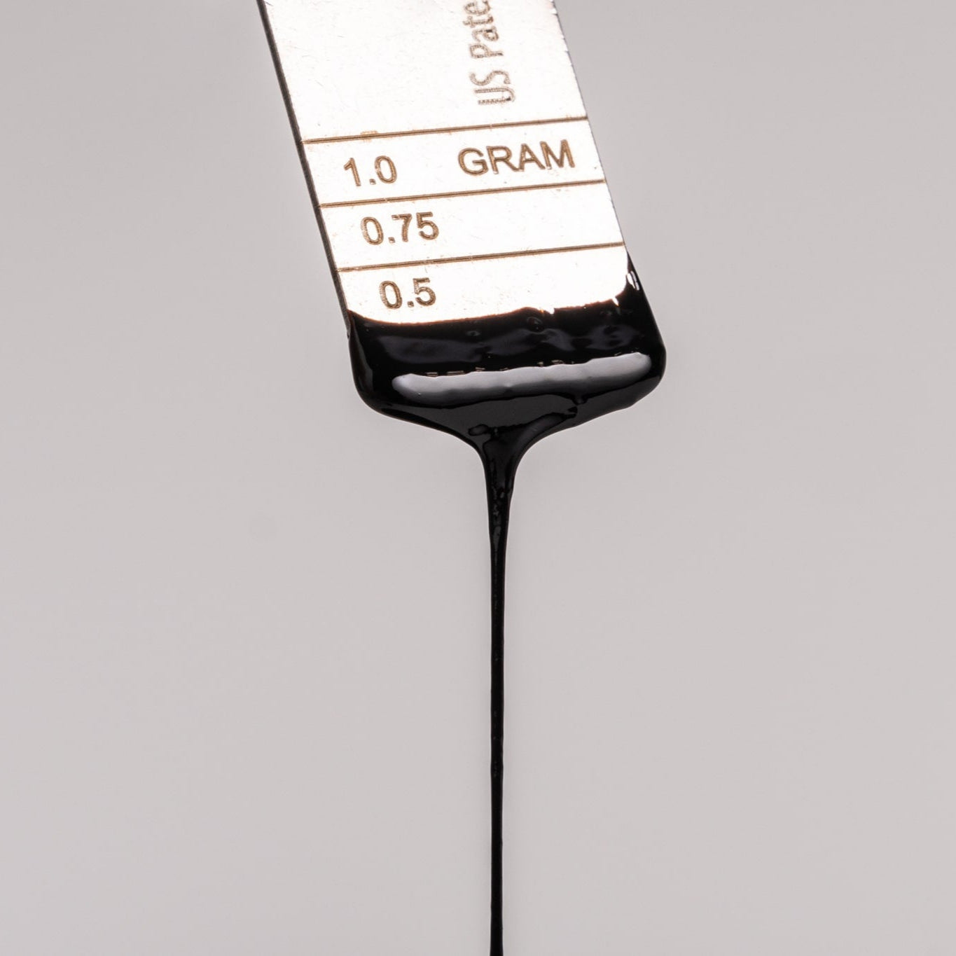 Lifecykel Shilajit syrup in a metal measurement.